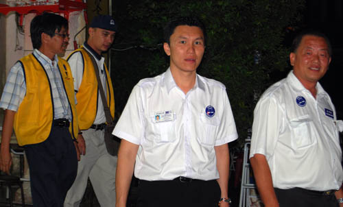 Chew [R-L] and Liew walking out of a restaurant after meeting the patrons