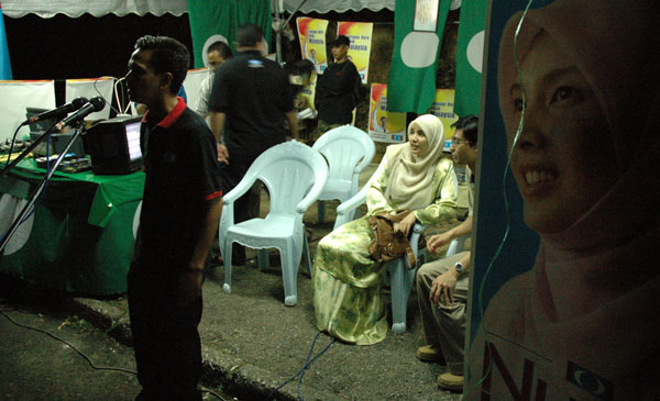 The roadside pondok ceramah where Nurul Izzah (next to her husband) awaits her turn to speak.