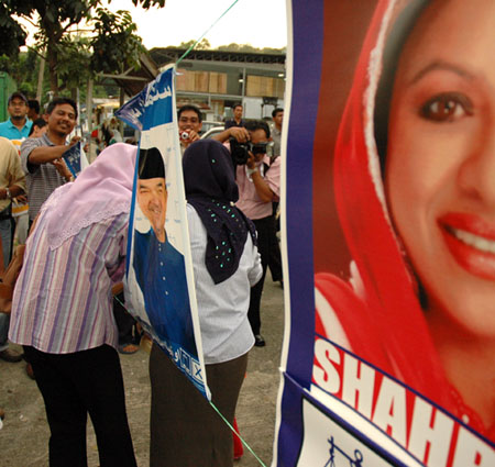 Posing for cameras in between BN banners and posters.